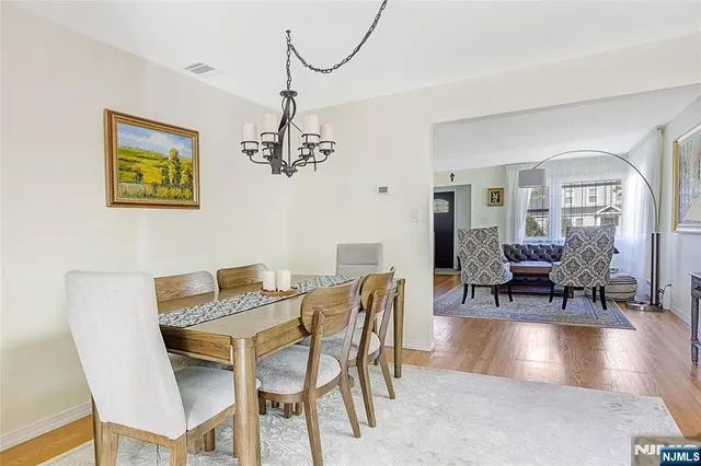 a view of a dining room with furniture wooden floor and a chandelier