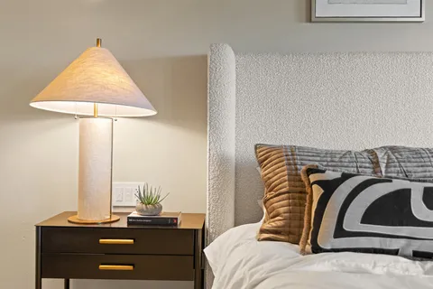 a view of a house with brick walls and a yard with plants