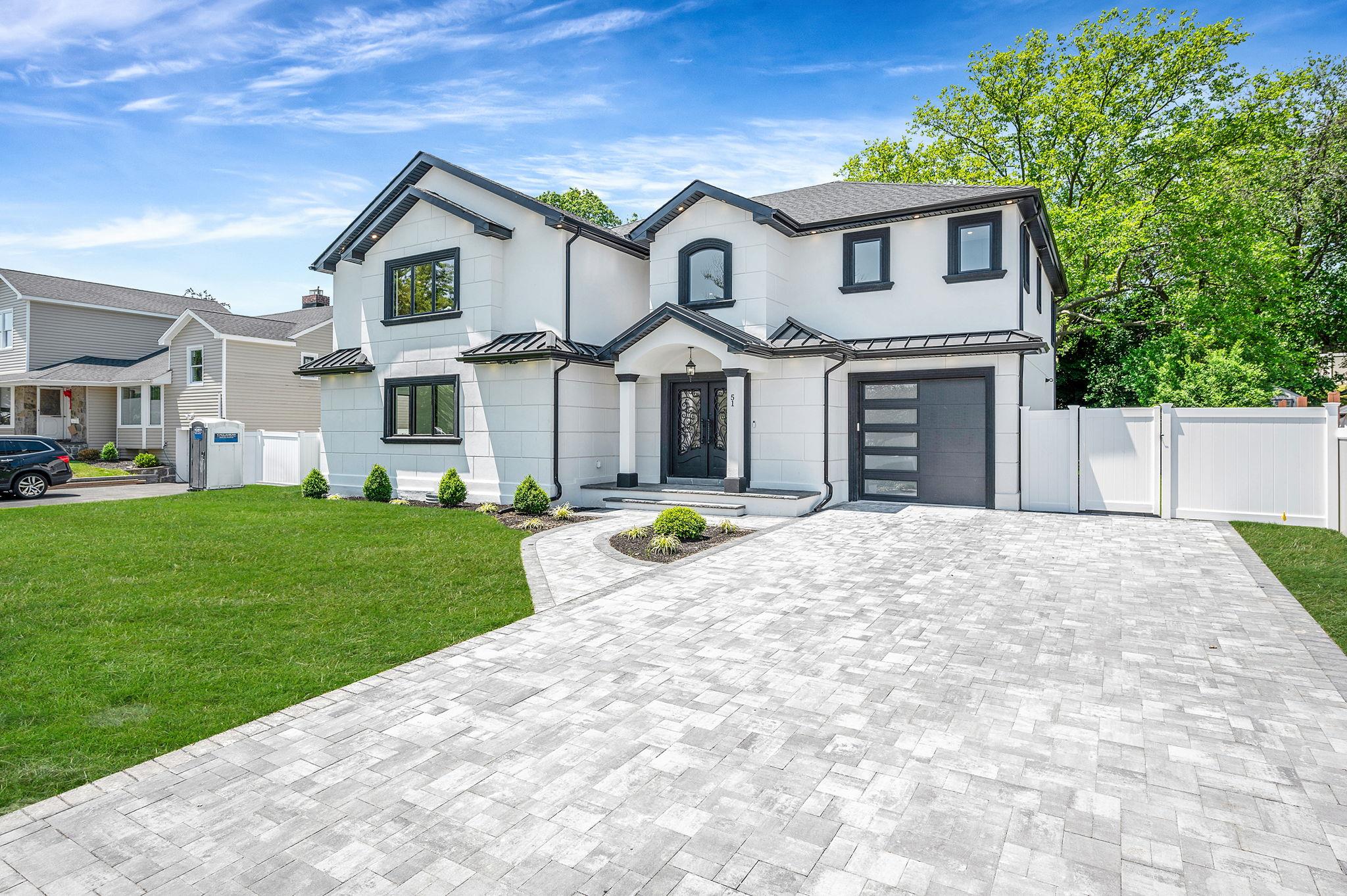 51 Maytime Drive Jericho, NY 11753 - Photo 1 of 1 a front view of a house with a garden and yard