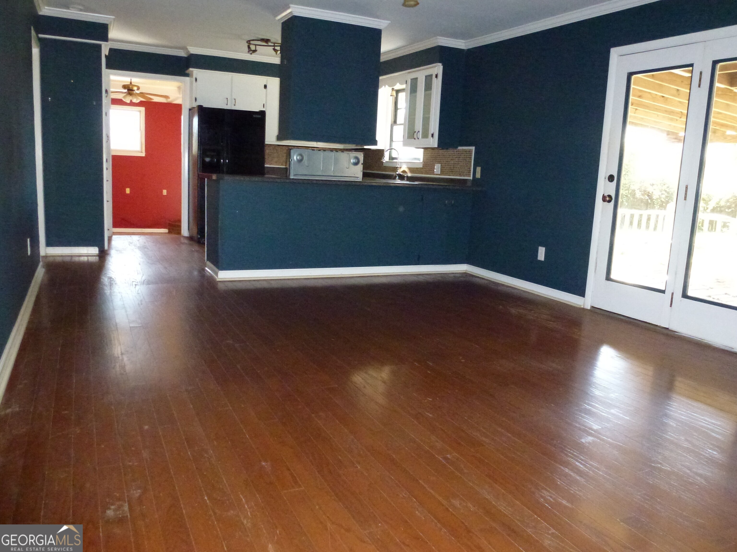 606 Park Avenue Claxton, GA 30417 - Photo 12 of 38 a living room with hard wood floors and a kitchen