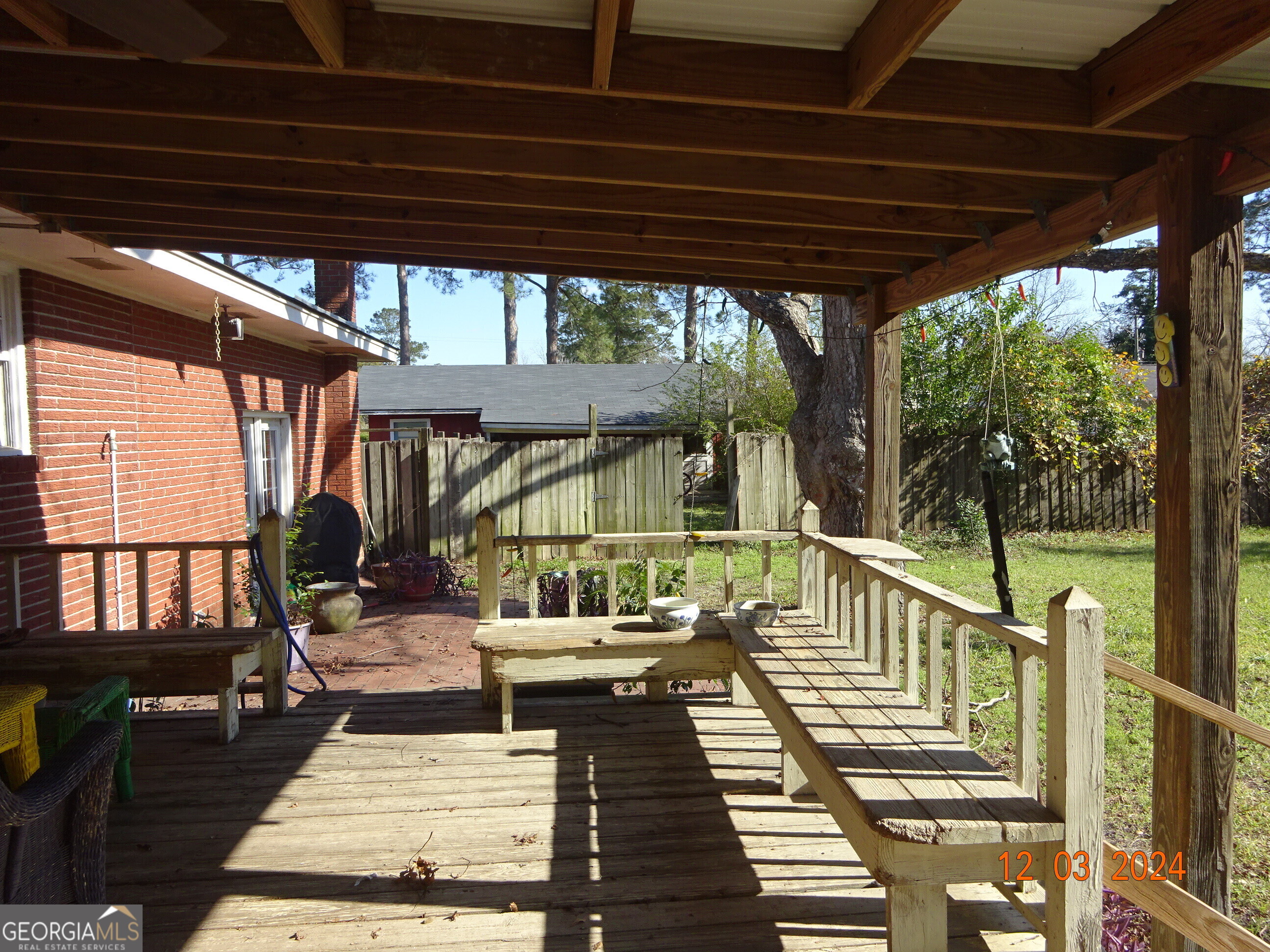 606 Park Avenue Claxton, GA 30417 - Photo 37 of 38 a view of a balcony with chairs and wooden floor