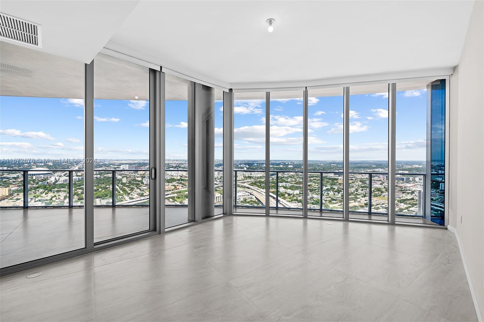 851 Northeast 1st Avenue, Unit PH5402 Miami, FL 33132 - Photo 20 of 61 a view of an empty room with wooden floor and walls