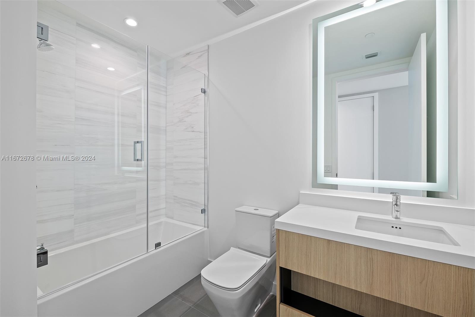 851 Northeast 1st Avenue, Unit PH5402 Miami, FL 33132 - Photo 21 of 61 a bathroom with a sink a toilet and a bathtub