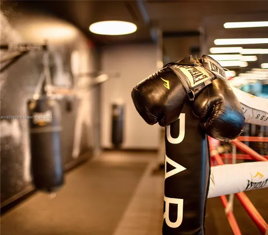 a table & chairs sitting in a bedroom next to a window