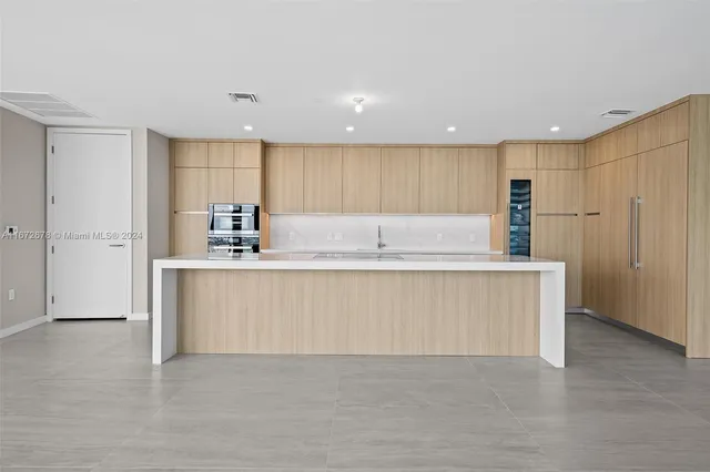 a kitchen with kitchen island cabinets and refrigerator