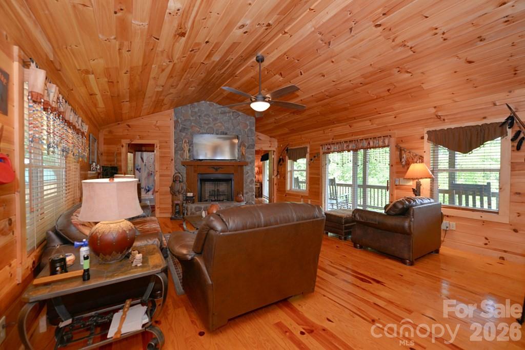 470 Bear Ridge Road Tuckasegee, NC 28783 - Photo 13 of 28 a living room with furniture a fireplace and a large window