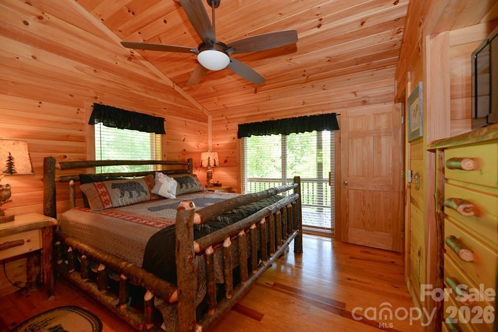 470 Bear Ridge Road Tuckasegee, NC 28783 - Photo 18 of 28 a bedroom with a bed and wooden floor