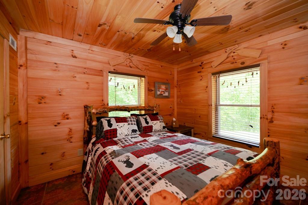 470 Bear Ridge Road Tuckasegee, NC 28783 - Photo 23 of 28 a bed sitting in a bedroom next to a window