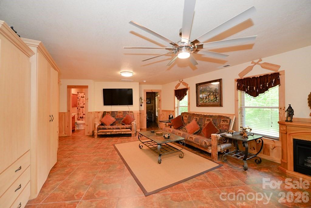 470 Bear Ridge Road Tuckasegee, NC 28783 - Photo 24 of 28 a living room with furniture and a flat screen tv