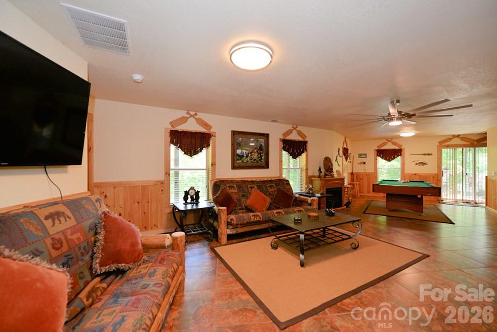 470 Bear Ridge Road Tuckasegee, NC 28783 - Photo 25 of 28 a living room with furniture and a flat screen tv