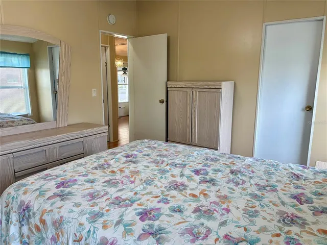 a bedroom with a bed and a dresser