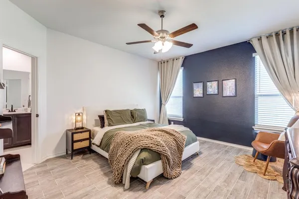 a bedroom with a bed and a chandelier