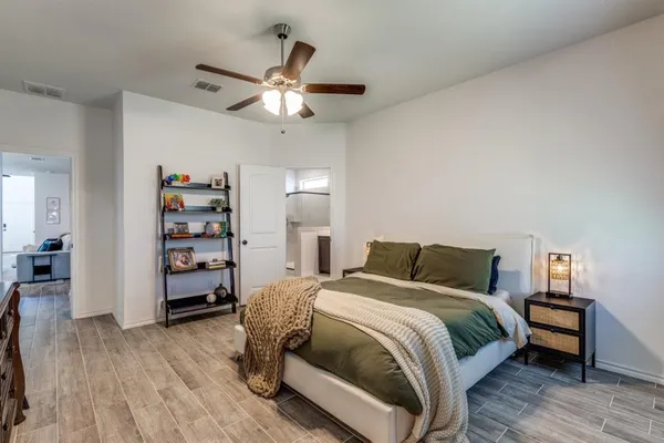 a bedroom with a bed and a chandelier