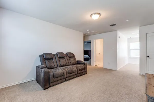 a living room with furniture and a walk in closet