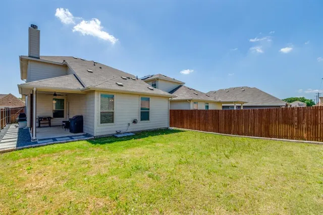 a view of a house with a yard and sitting area