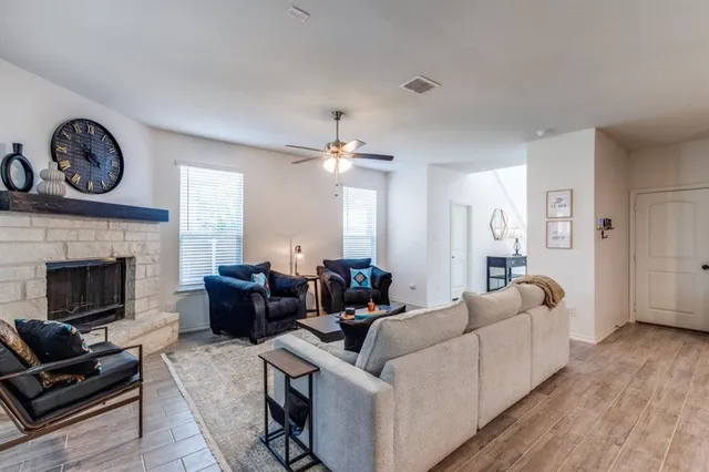 a living room with furniture a clock and a fireplace