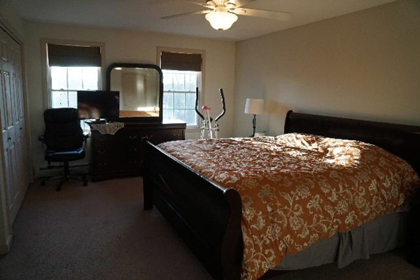 175 Old Fall River Road Swansea, MA 02777 - Photo 9 of 21 a bed sitting in a bedroom next to a window