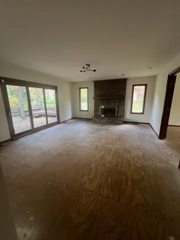 an empty room with a empty space and windows