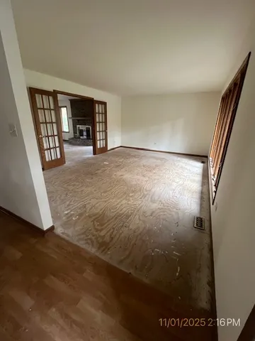 an empty room with a fireplace and a window