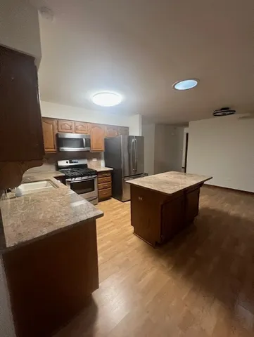 outdoor kitchen with stainless steel appliances granite countertop a sink stove and oven