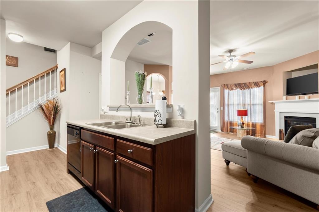 1207 Mistyhaynes Way Grayson, GA 30017 - Photo 12 of 37 a living room with furniture a fireplace and a flat screen tv