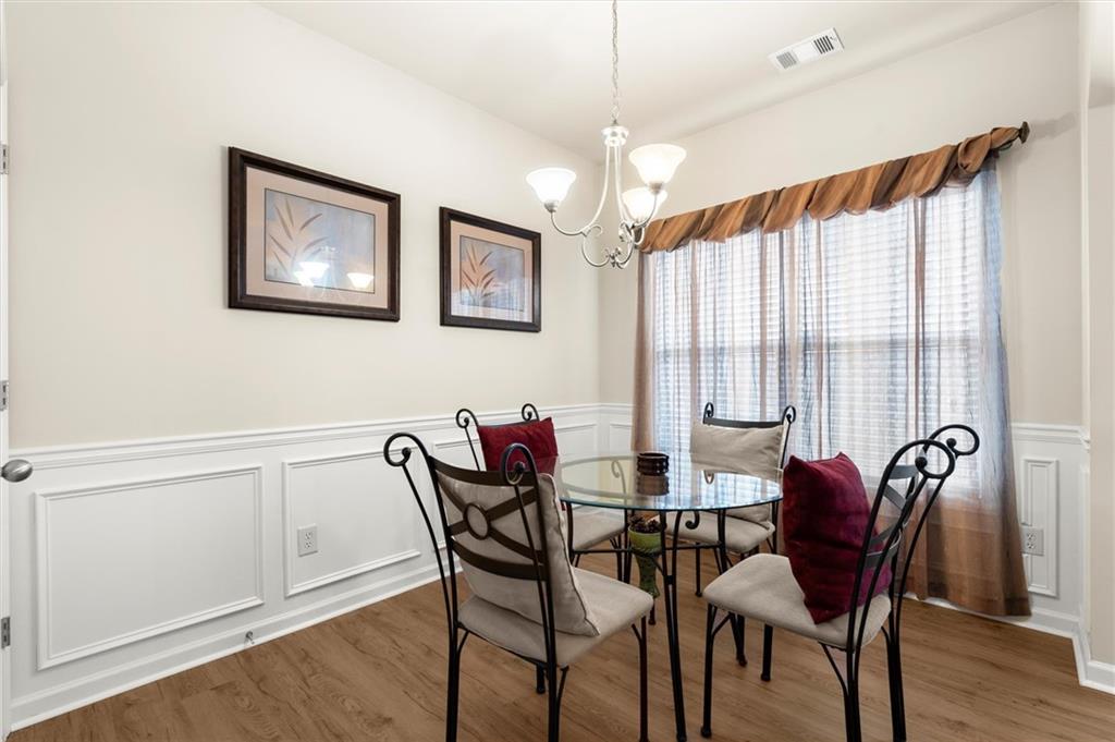 1207 Mistyhaynes Way Grayson, GA 30017 - Photo 14 of 37 a view of a dining room with furniture and wooden floor