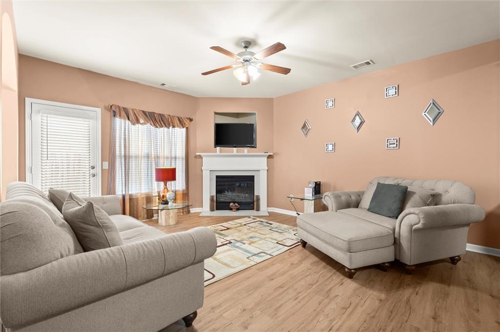 1207 Mistyhaynes Way Grayson, GA 30017 - Photo 16 of 37 a living room with furniture fireplace and a large window
