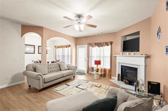 a living room with furniture a fireplace and a flat screen tv