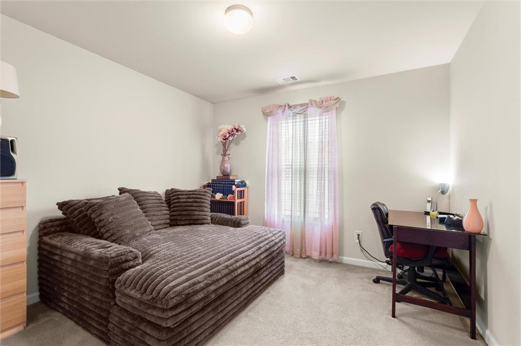 1207 Mistyhaynes Way Grayson, GA 30017 - Photo 21 of 37 a bedroom with a bed and a window