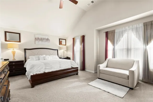 a spacious bedroom with a bed and a couch