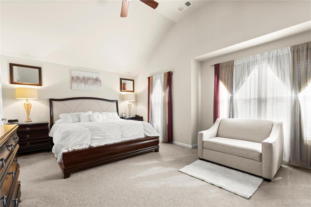 1207 Mistyhaynes Way Grayson, GA 30017 - Photo 24 of 37 a spacious bedroom with a bed and a couch