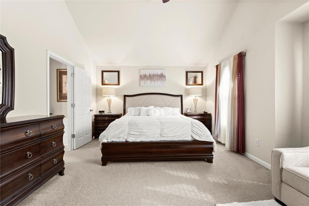 1207 Mistyhaynes Way Grayson, GA 30017 - Photo 25 of 37 a bedroom with a bed and a window