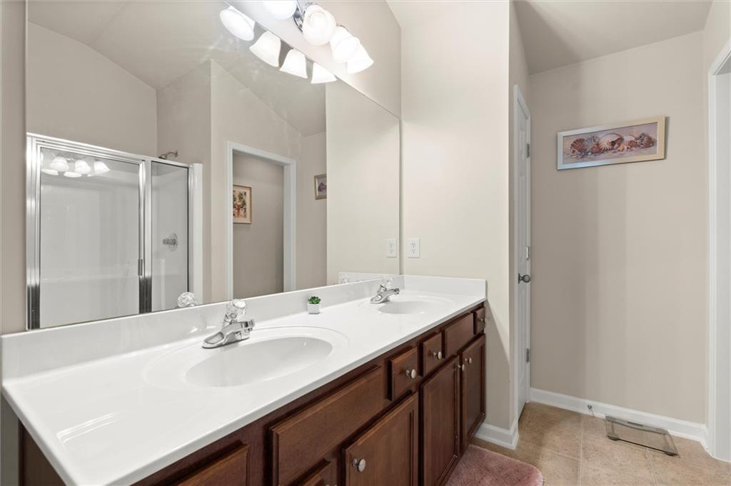 1207 Mistyhaynes Way Grayson, GA 30017 - Photo 27 of 37 a bathroom with a sink a mirror and a shower