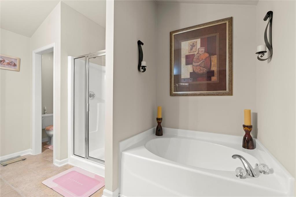 1207 Mistyhaynes Way Grayson, GA 30017 - Photo 28 of 37 a white bath tub sitting next to a bathroom