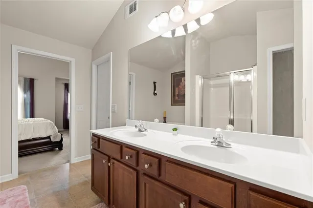 a bathroom with a sink double vanity and a mirror