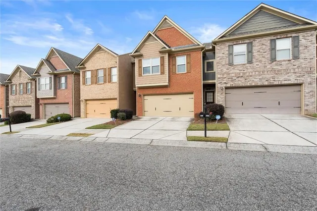 a front view of a house with a yard
