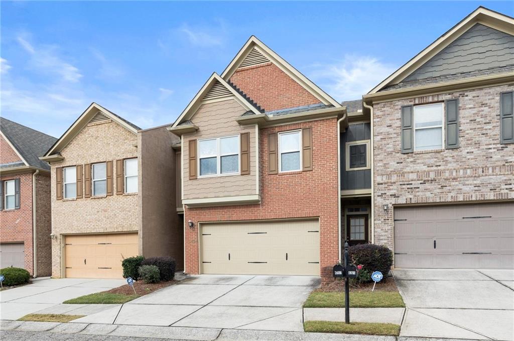 1207 Mistyhaynes Way Grayson, GA 30017 - Photo 4 of 37 a view of a brick house with a yard and large windows