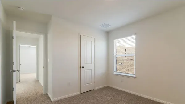 a view of an empty room and entryway