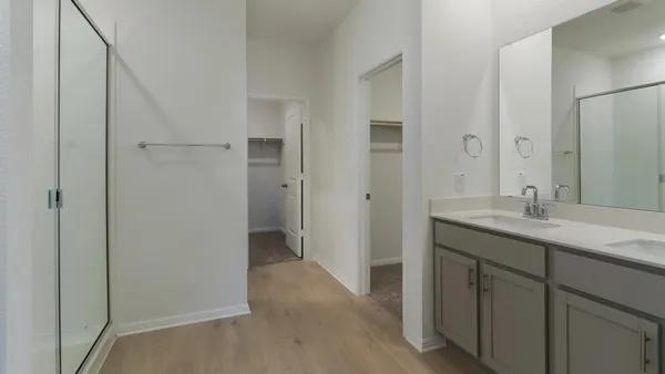 a bathroom with a double vanity sink and mirror