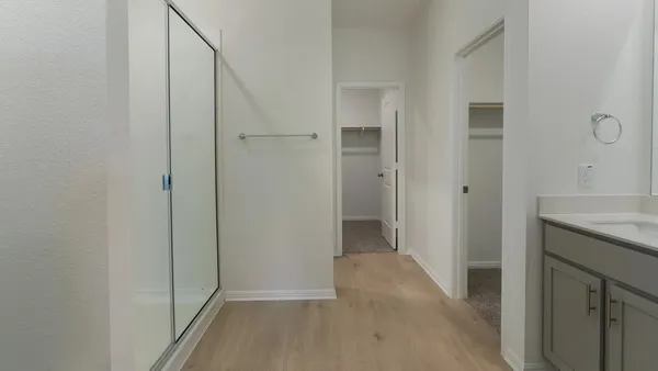 a view of a hallway with wooden floor