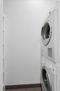 a living room with furniture a couch and a potted plant