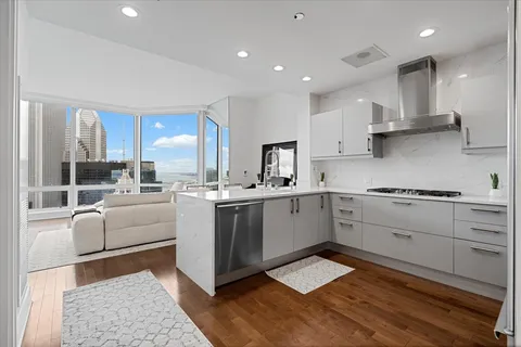 a kitchen with a sink stainless steel appliances and cabinets