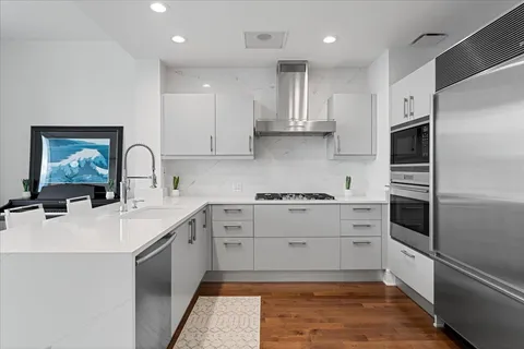 a kitchen with a sink stainless steel appliances and cabinets
