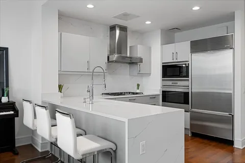 a living room with furniture plant and a large window