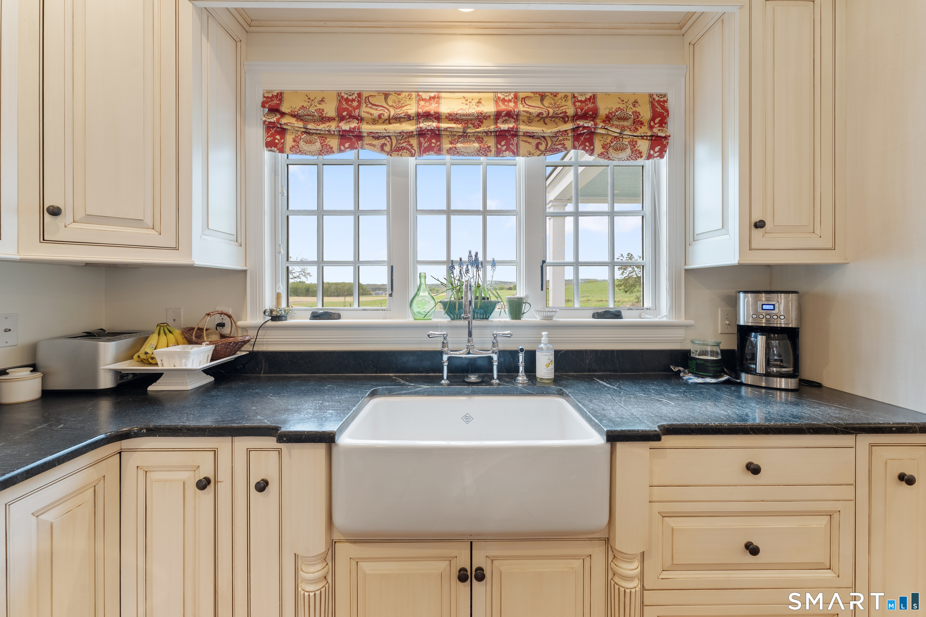 155 Paine Road Woodstock, CT 06281 - Photo 7 of 40 a kitchen with granite countertop a sink a window and cabinets