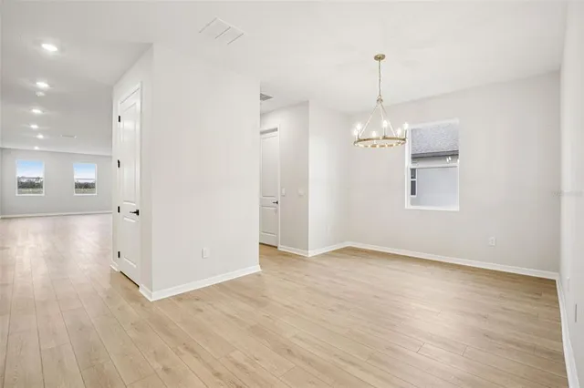 a kitchen with stainless steel appliances granite countertop a sink a stove and a wooden floors