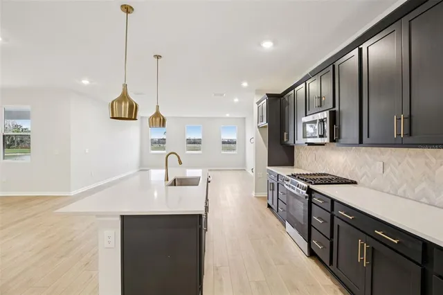 a kitchen with sink cabinets and outdoor space