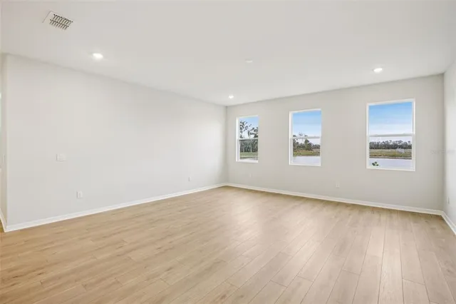 a view of a kitchen with a wooden floor and a window