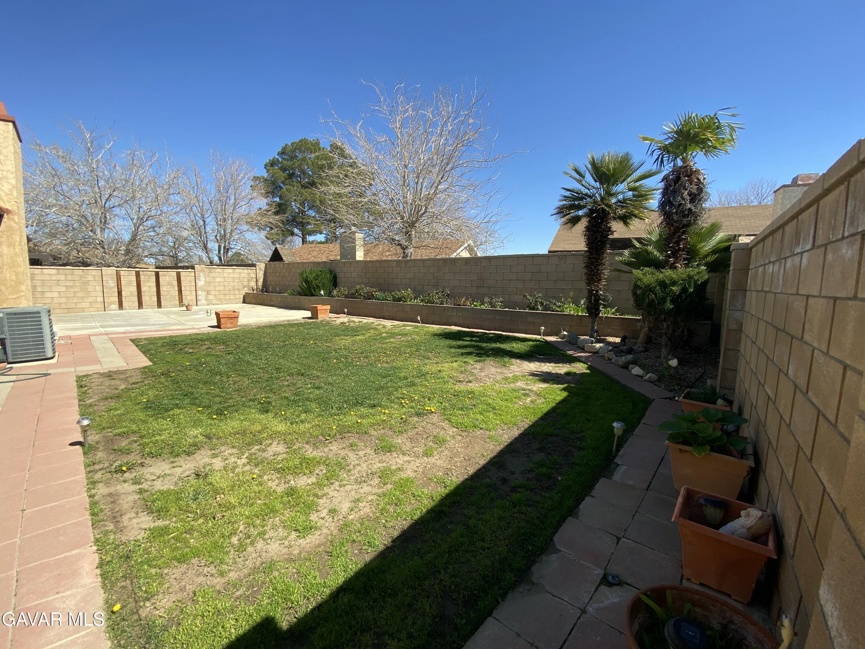 44034 4th Street East Lancaster, CA 93535 - Photo 12 of 14 a view of a swimming pool with a yard