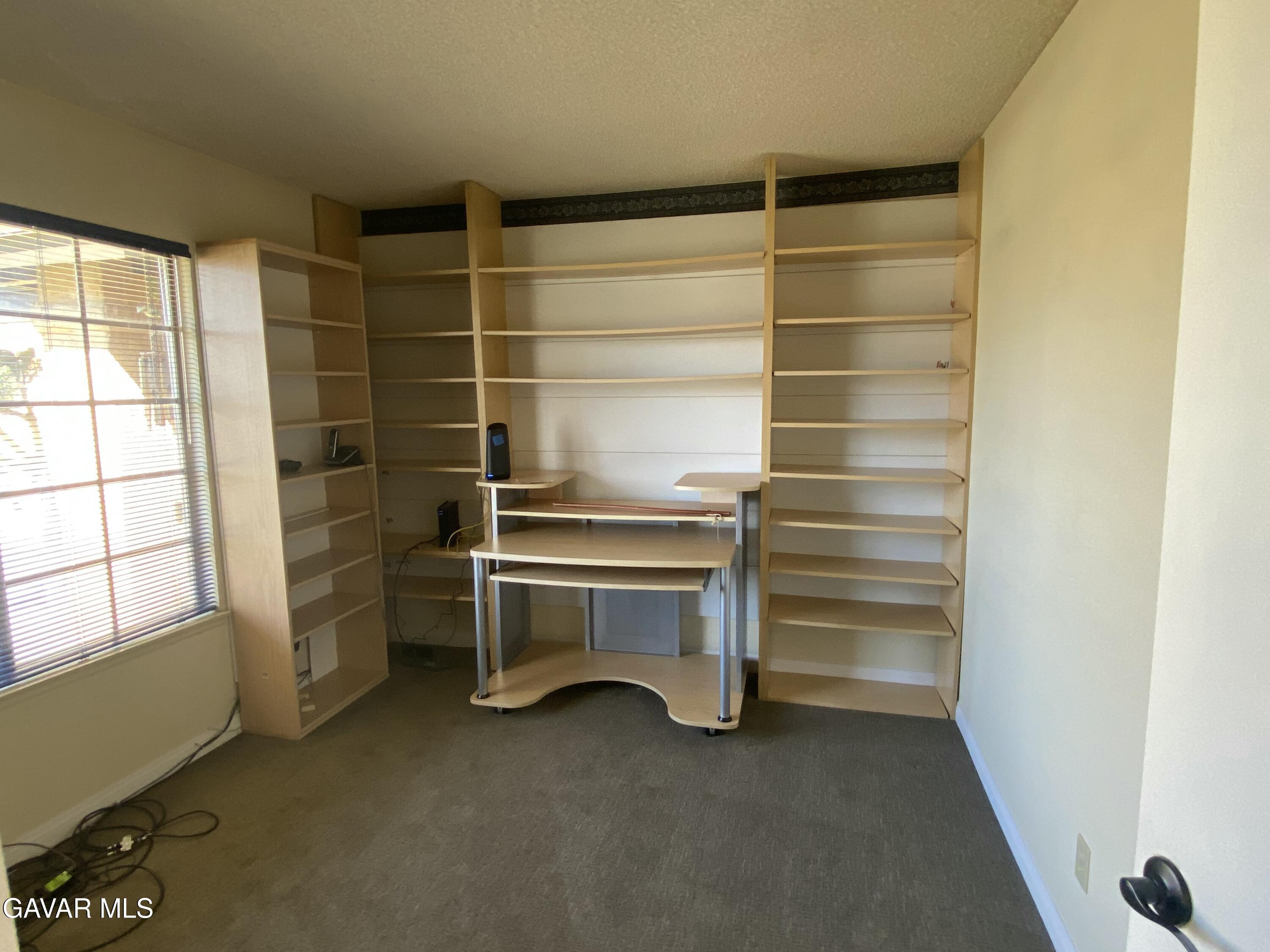 44034 4th Street East Lancaster, CA 93535 - Photo 13 of 14 a view of walk in closet with empty racks